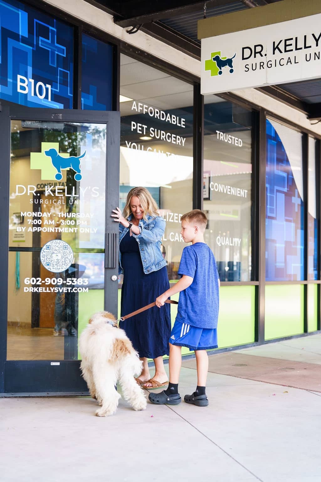 Mother and son walk their dog into Dr. Kelly’s Surgical Unit Peoria clinic.